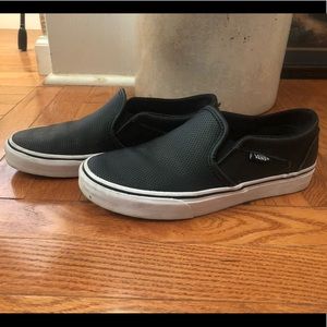 Woman’s black leather vans